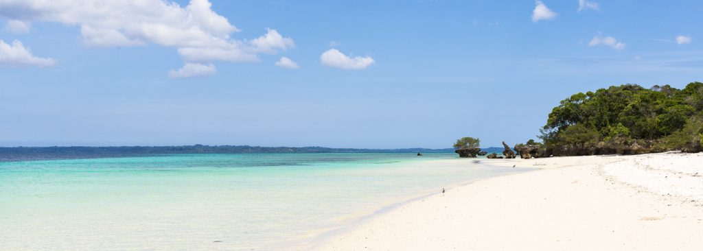 Pristine white tropical beach with blue sea in Pemba